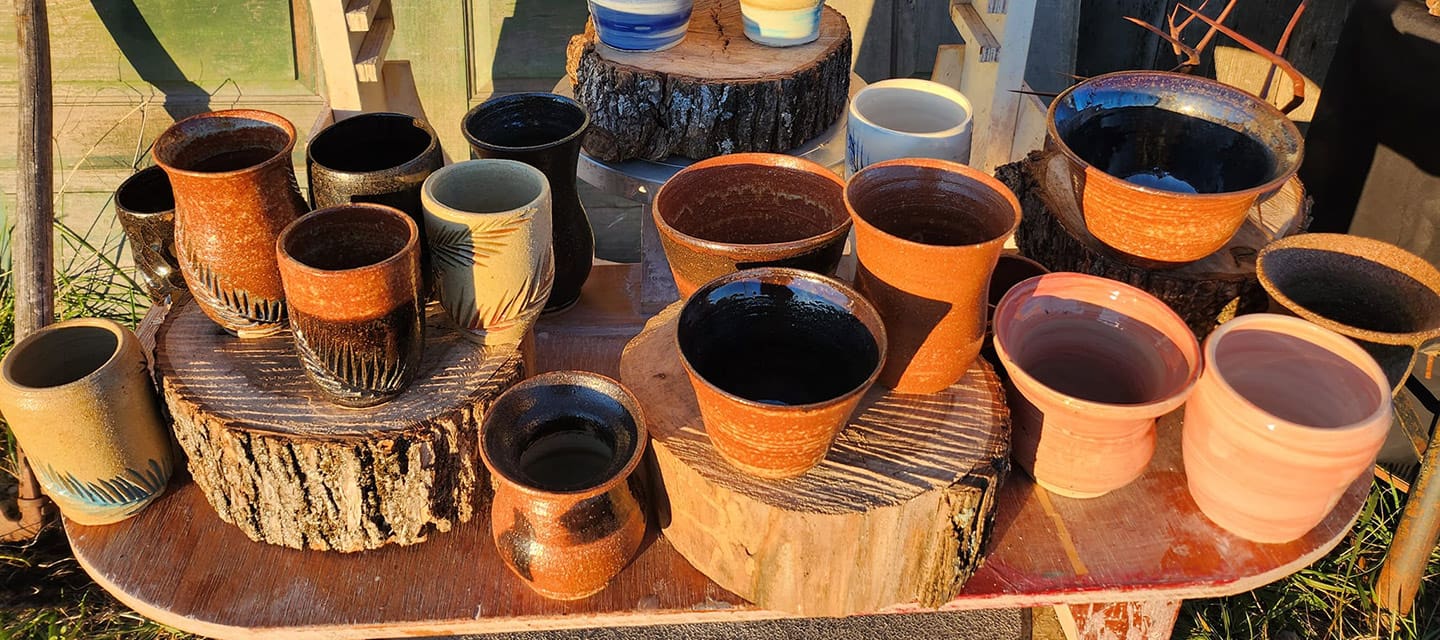 Colorful metallic statue of a jockey riding a horse outside a brick building.